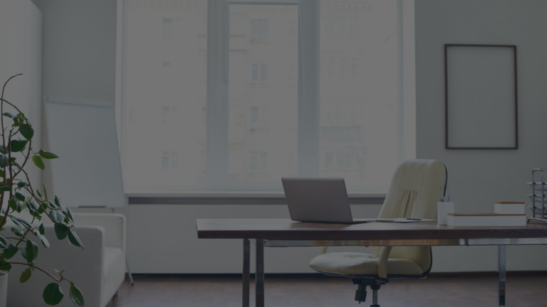 Empty office desk symbolizing cost of vacancy.